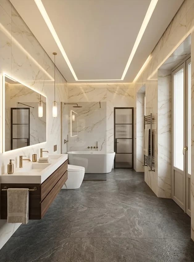 After: the same room in veined marble with a freestanding bath, a wall-hung timber vanity, a backlit mirror and a dark stone floor.