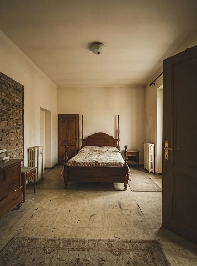 Before: a bedroom with bare patched plaster, exposed brickwork, a damaged timber floor and an old bedstead.